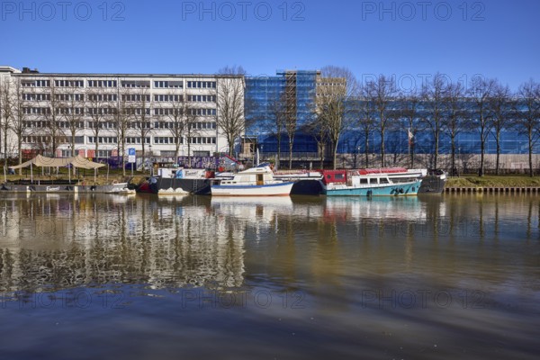River Saar, ships, modern architecture, concrete architecture, former tax office, abstract reflections, reflections on the water surface, blue sky, cloudless, Saarbrücken, state capital, regional association Saarbrücken, Saarland, Germany