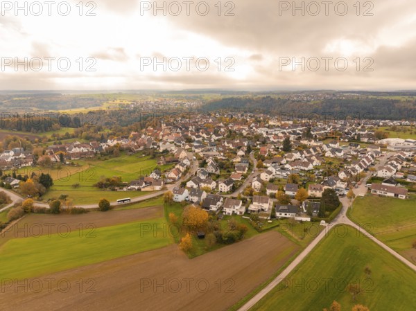 Far-reaching view over a village and fields in an autumnal atmosphere, Tiefenbronn, Germany