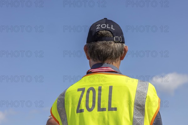 Customs officers wearing high-visibility waistcoats, Schönefeld Airport apron, Brandenburg, Germany