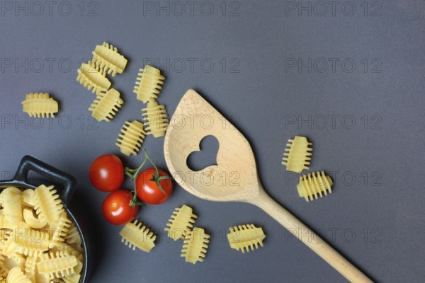 Cooking spoon with heart and Italian pasta, Radiatori variety