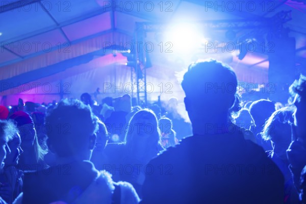 Party in full swing with blue lights and dancing people, carnival, Schlagerkuchen Donzdorf, Landkreis Göppingen, Germany