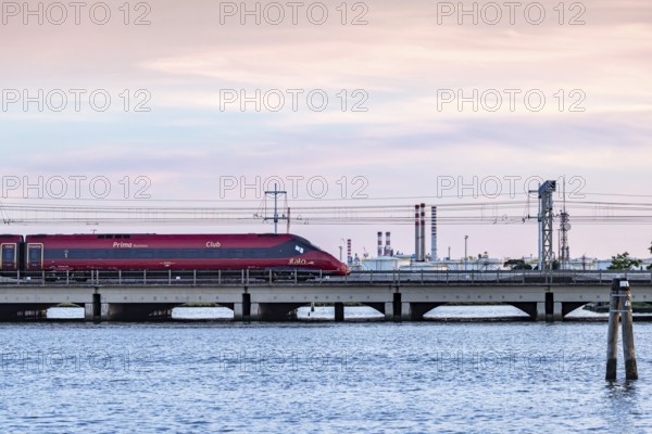 High-speed train operated by the private Italian railway company Italo. Ponte della Libertà, the bridge connecting Venice with the mainland. Venice, Venezia, Italy