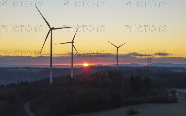 Wind turbines at sunrise with a road in the foreground, Rems Valley, Baden-Württemberg, Germany