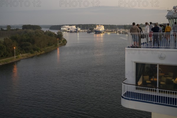 Travellers follow the Finnish ferry entering the port of Travemünde, Bay of Lübeck, Lübeck, Schleswig-Holstein, Germany