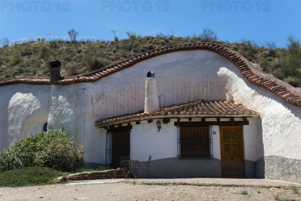 White house with charming rustic style in a hill with clear blue sky in summer, Cuevas del Zenete, cave houses, La Calahorra, Guadix, Granada province, Andalucia, Spain