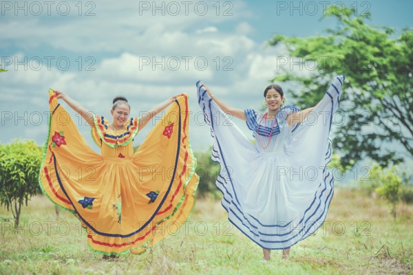 Portrait of smiling girls in national folk costume in a field. Women wearing traditional Nicaraguan folk costume in a field