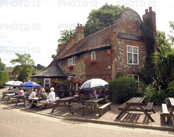 People sitting outside Adam and Eve pub, the oldest in Norwich, Norfolk, England, UK