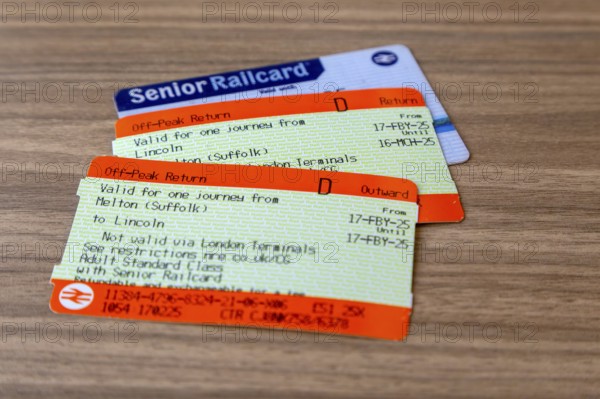 Railway train off-peak return tickets with Senior Railcard oblique angle view to table, UK