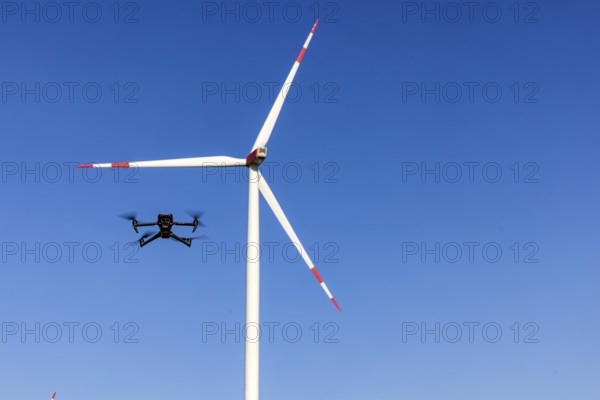 A Mavic 3 Pro drone flies for a wind turbine in a wind farm. Dornstadt, Baden-Württemberg, Germany