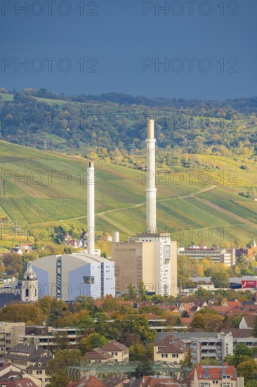 Industrial building with tall chimneys against an urban backdrop and clear sky, Stuttgart, Germany