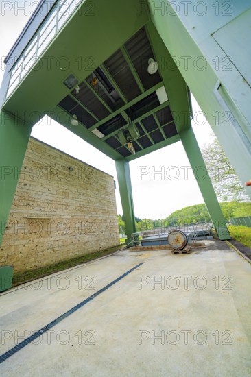 Industrial structure with green construction and machinery on an outdoor concrete floor, Glems reservoir, Swabian Alb, Germany