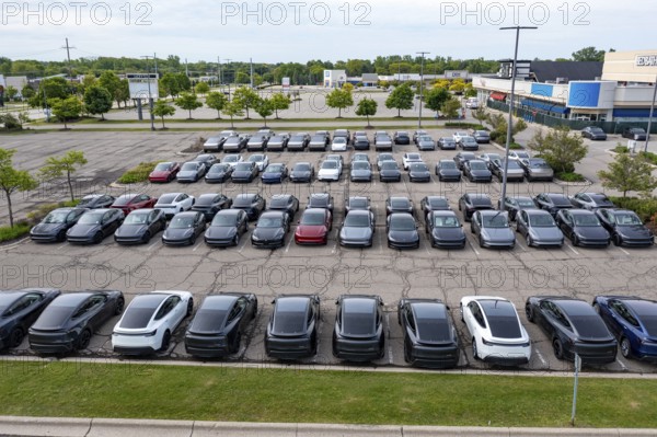 Farmington Hills, Michigan USA - 30 May 2025 - Many dozens of unsold Tesla electric vehicles, including Cybertrucks, are stored in the parking lot of a closed shopping center in suburban Detroit. Tesla sales have fallen in 2025, at least partly in response to CEO Elon Musk's political activity in the Trump Administration