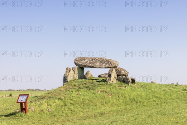 Passage grave on a hill with big boulders in a rural landscape with a clear blue sky Falköping, Luttra, Sweden