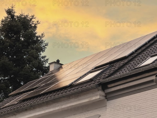Solar panels at sunset on the roof of a detached house in Düsseldorf, Germany