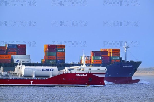 Container ship, containership Amalthea loaded with containers and oil, chemical tanker Ramelia sailing side by side