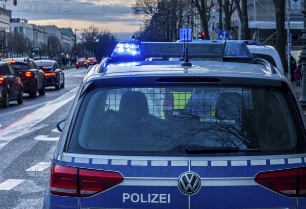 Police vehicles with flashing lights switched on, special operation at the Berlin State Library, Unter den Linden, Berlin, Germany