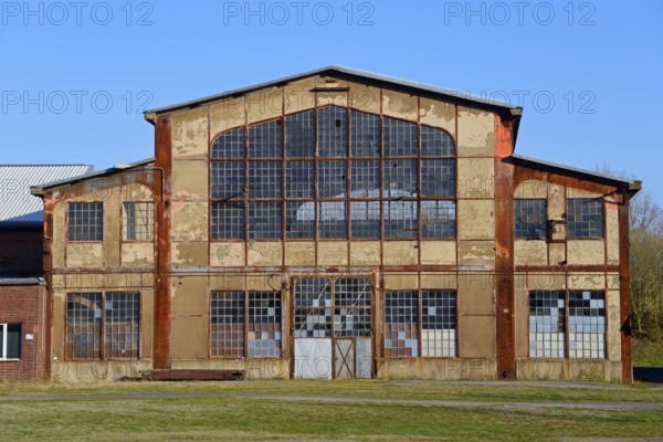 Abandoned factory with large windows and rusty structures, Ilseder Hütte, Ilsede, Peine district, Lower Saxony, Germany