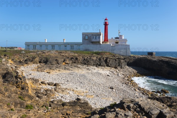 Lighthouse on rocky coast with clear sky and sea view, Farol do Cabo Raso, São Brás de Sanxete fortress, Estoril, Cascais, Parque Natural de Sintra-Cascais, Portugal