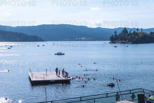 Tourists bathing in Lake Schluch in the Black Forest in Germany