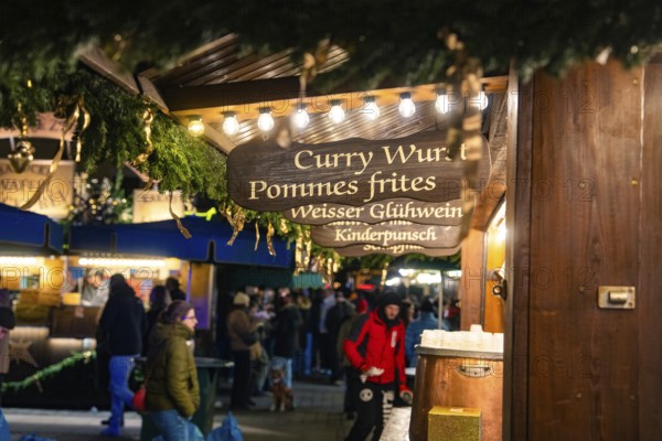 A food stall at a Christmas market with winter lighting, Christmas market Ludwigsburg, Germany