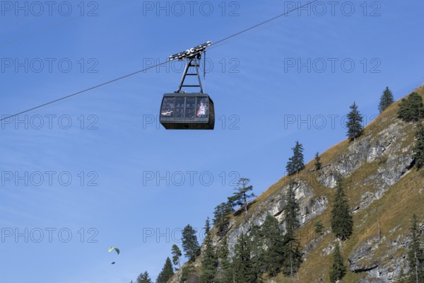 Floating cable car cabin above steep mountain landscape with pine trees, Tegelbergbahn, Schwangau, Ostallgäu, Allgäu, Swabia, Upper Bavaria, Bavaria, Germany