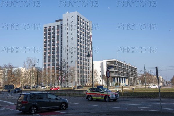 Modern high-rise building in the sunshine with passing cars, Campus Tower of the Otto-von-Guericke University, serves as a hall of residence, Magdeburg, Saxony-Anhalt, Germany