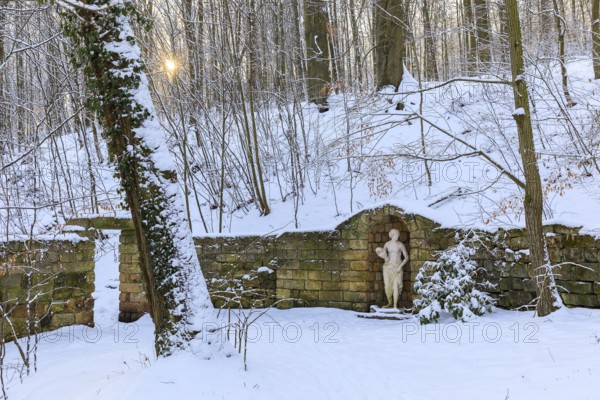 Sculpture of a woman and wall, winter in the landscape park of Dittersbach Castle, Dürrröhrsdorf-Dittersbach, Saxony, Germany
