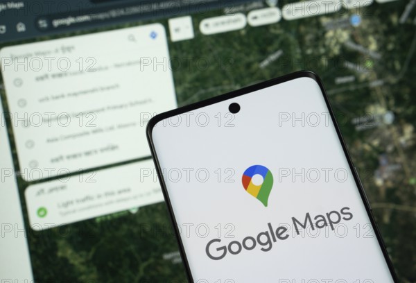 The logo of the google maps is displayed on a smartphone screen, and the website google maps is visible on a computer screen in the background
