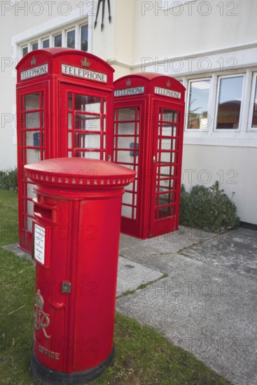 Red telephone boxes and letterbox in front of a British-style building on the Falkland Islands, Port Stanley, Falkland Islands, Argentina