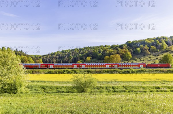 RegionalExpress RE5 to Friedrichshafen travelling over the Swabian Alb. Idyllic landscape near Lonsee in spring. Lonsee, Baden-Württemberg, Germany