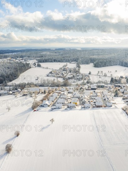 Vast, snow-covered fields and a village under a cloudy sky, Oberreichenbach, Black Forest, district of Calw, Germany