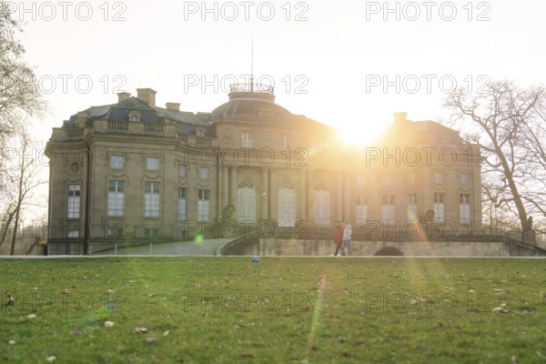 The historic palace at sunrise, surrounded by green lawns and trees, Domäne Monrepos, Ludwigsburg, Germany