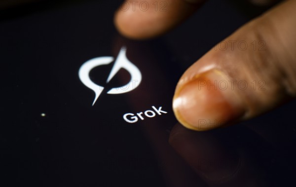 In this photo Illustration a person taps Grok AI application icon on a tablet device on 24 May 2025 in New Delhi, India