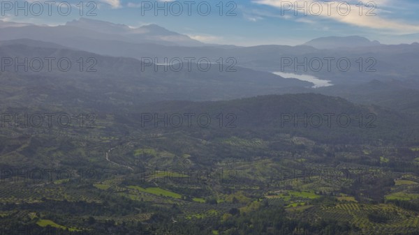Sky exchanged, Sweeping view of a hilly, green landscape with mountains in the background under a blue sky with clouds, Wide view from the summit, Profitis Ilias, Rhodes, Dodecanese, Greek Islands, Greece