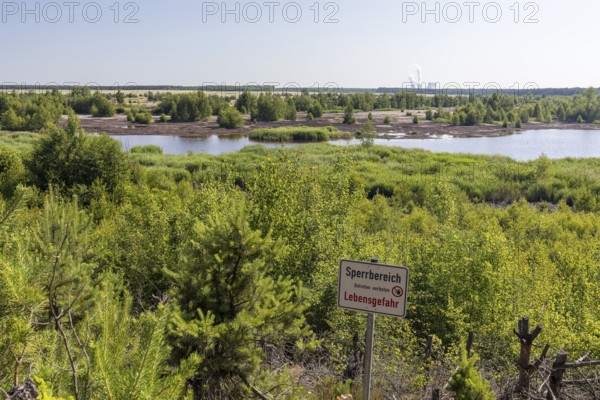 Viewpoint at the still flooded Bergener See with Sperrschidl, in the background the towers of the Schwarze Pumpe power station, Bergener See in the Lusatian Lakeland, Saxony, Germany
