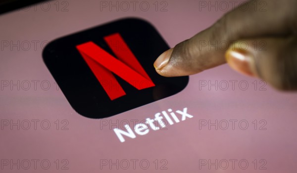 In this photo Illustration a person taps Netflix App icon on a tablet device on 24 May 2025 in New Delhi, India