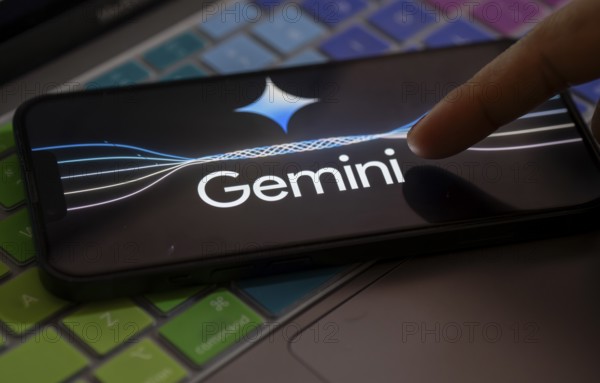 Guwahati, India. 8 December 2023. In this photo illustration a Gemini logo is displayed on a smartphone on a computer keyboard