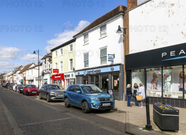 Shops and shoppers in North Street, Sudbury, Suffolk, England, UK - Peacocks, Caffe Nero