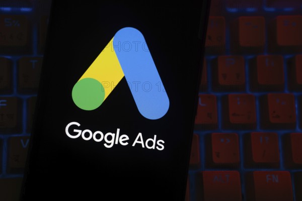 The logo of the Google Ads is displayed on a smartphone screen