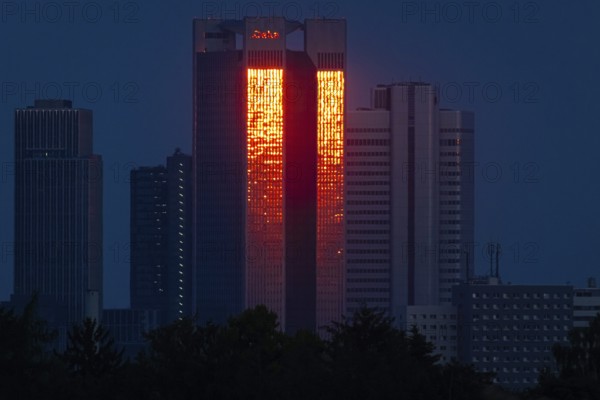 The glass façade of the 186 metre high Trianon Tower in Frankfurt am Main reflects the light of the setting sun. During the property crisis, the owner company, Geschäftshaus am Gendarmenmarkt GmbH, filed for insolvency at Frankfurt am Main Local Court, Frankfurt am Main, Hesse, Germany