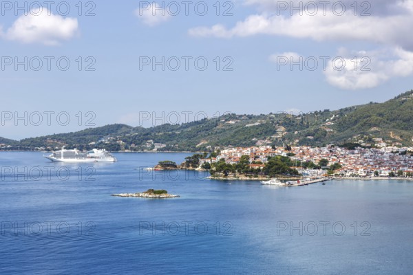 Skiathos town with cruise ship holidays by the sea on the Mediterranean island of Skiathos, Greece