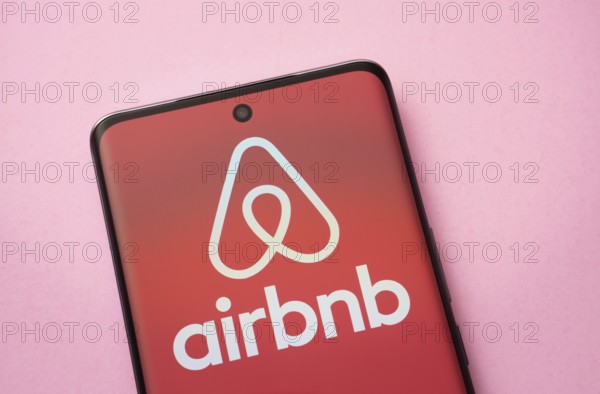 Airbnb logo is seen on a smartphone
