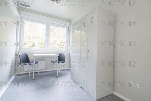 Simple office with desk, two chairs, a cupboard and large window, refugee accommodation Beermiß, Calmbach, Black Forest, Germany