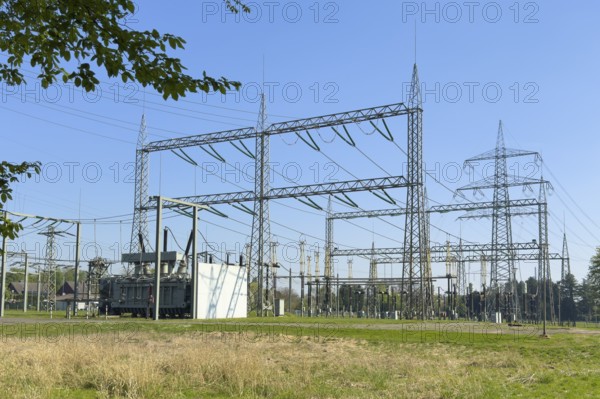 Substation with open-air switchgear for power distribution, in the background high electricity electricity electricity pylon with overhead power lines Power lines High-voltage lines Overhead electric lines on overhead power pylon Power pylon High-voltage pylon Support pylon, Germany