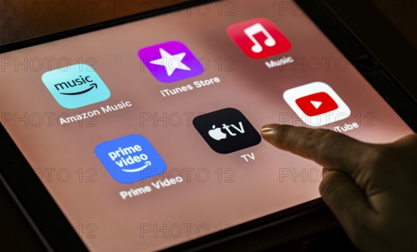 In this photo Illustration a person taps apple TV app icons on a tablet device on 24 May 2025 in New Delhi, India