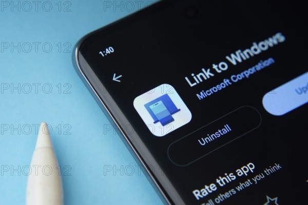 Dhaka, Bangladesh- 17 March 2025: The link to windows app from Google Playstore is displayed on a smartphone screen