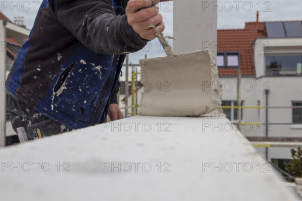 Bricklayers work on a new detached house