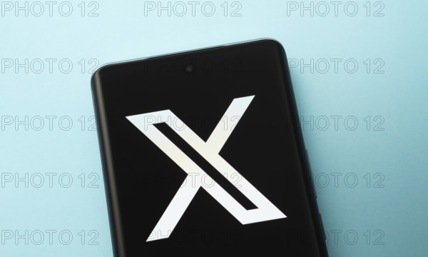 X (twitter) logo is seen on a smartphone