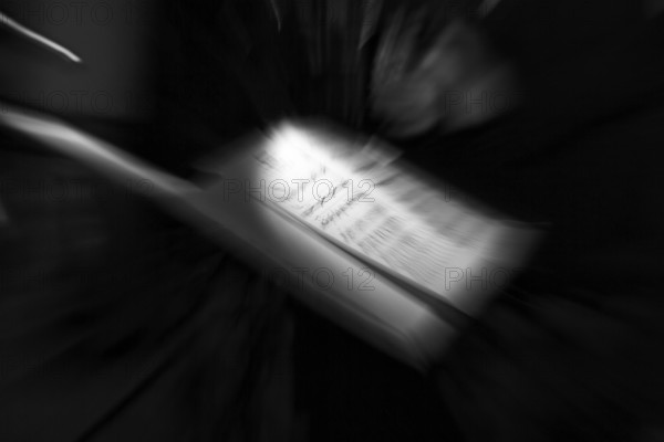 Illuminated sheet of music, music stand on a stage, milonga, tango dance event, concert, motion blur, monochrome, Germany