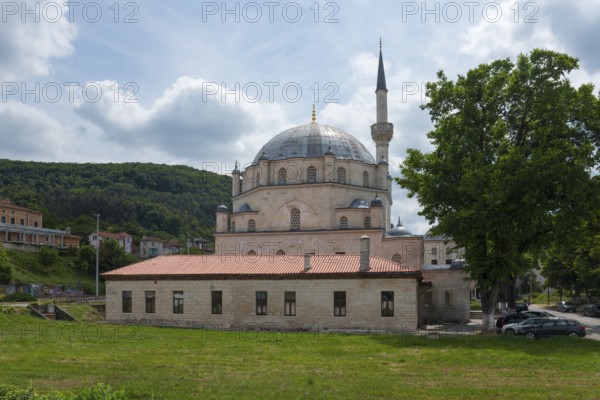 Mosque with dome and minaret, in front of it a car park with cars and a hill in the background, Tombul Mosque, Sherif Halil Pasha Mosque, Serif Halil Pasa Mosque, Serif Halil Pasa Camii, important Ottoman building, Shumen, Shumla, Unesco World Heritage Site, Bulgaria